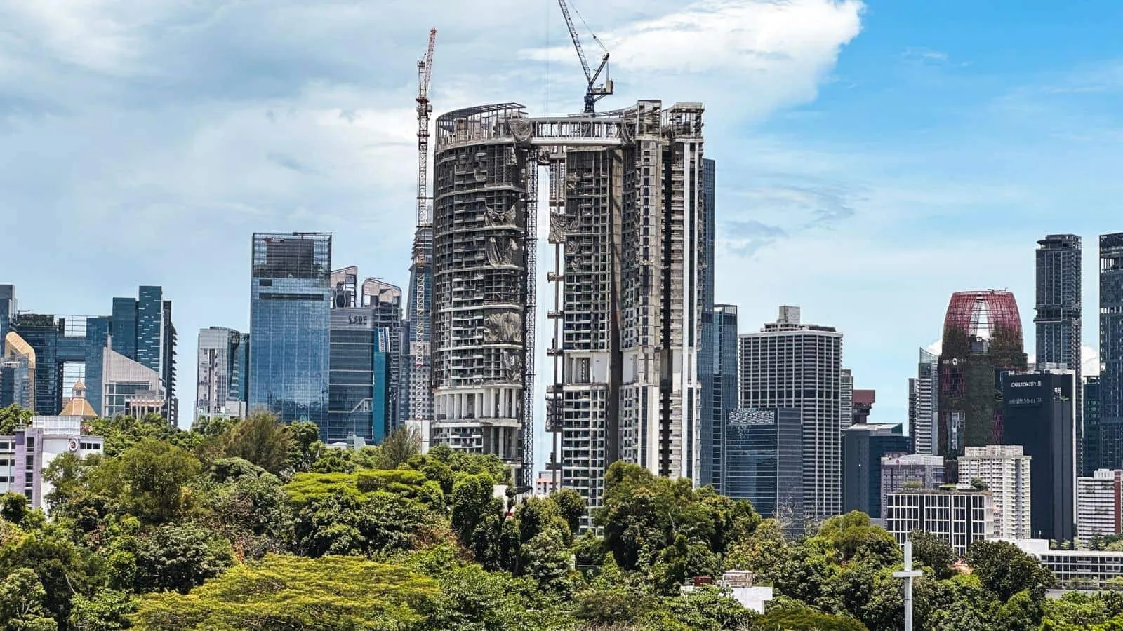 One Pearl Bank's twin curved towers under construction, wrapped in scaffolding and cranes against the Singapore skyline